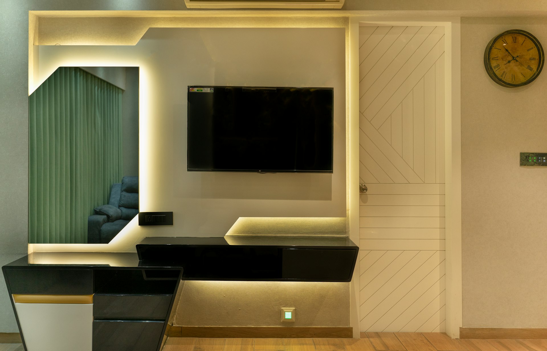 A modern living room with a TV and mirror.